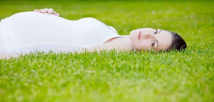 Beautiful pregnant woman in the park