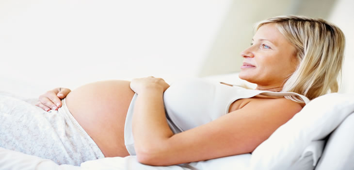 pregnant woman relaxing on the couch
